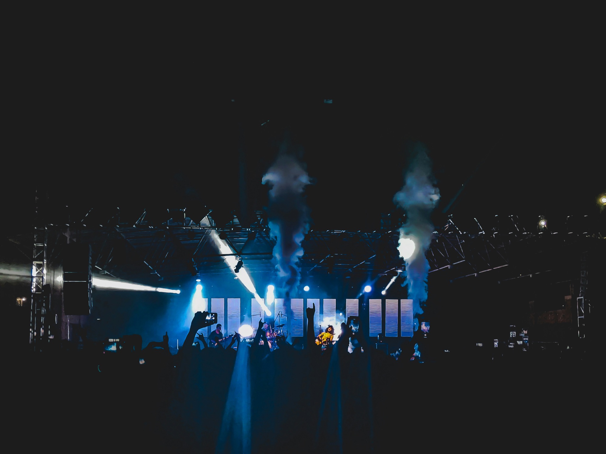 A lit stage with smoke and spotlights